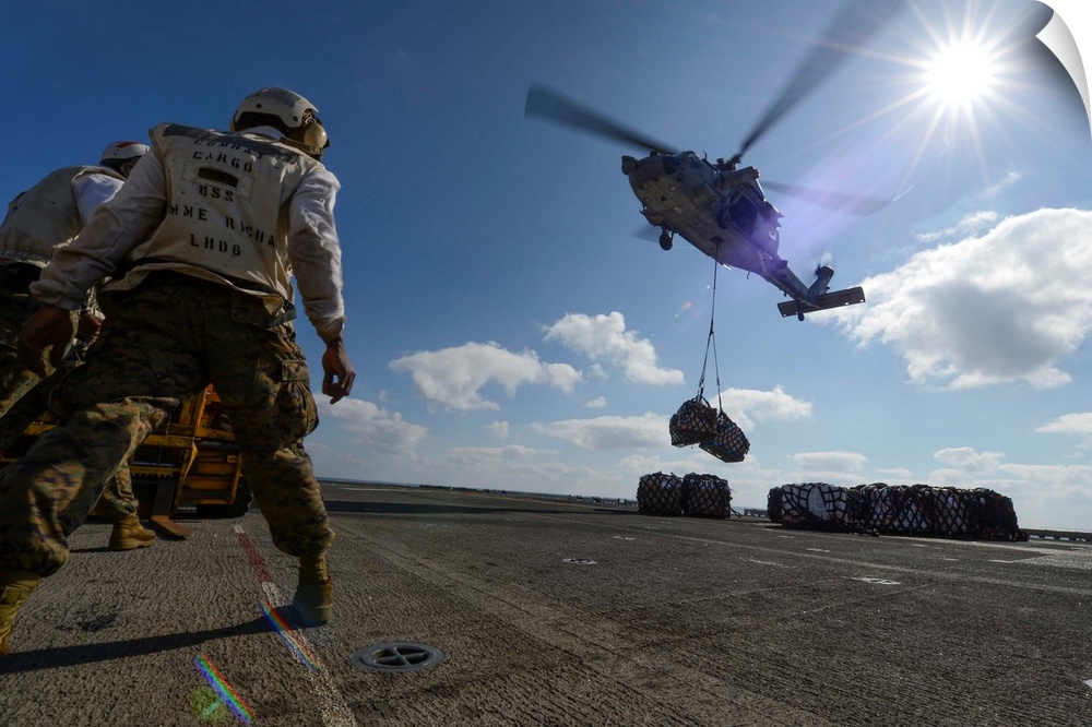 South China Sea, February 8, 2013 - An MH-60S Sea Hawk helicopter lowers pallets of supplies during a vertical replenishme...