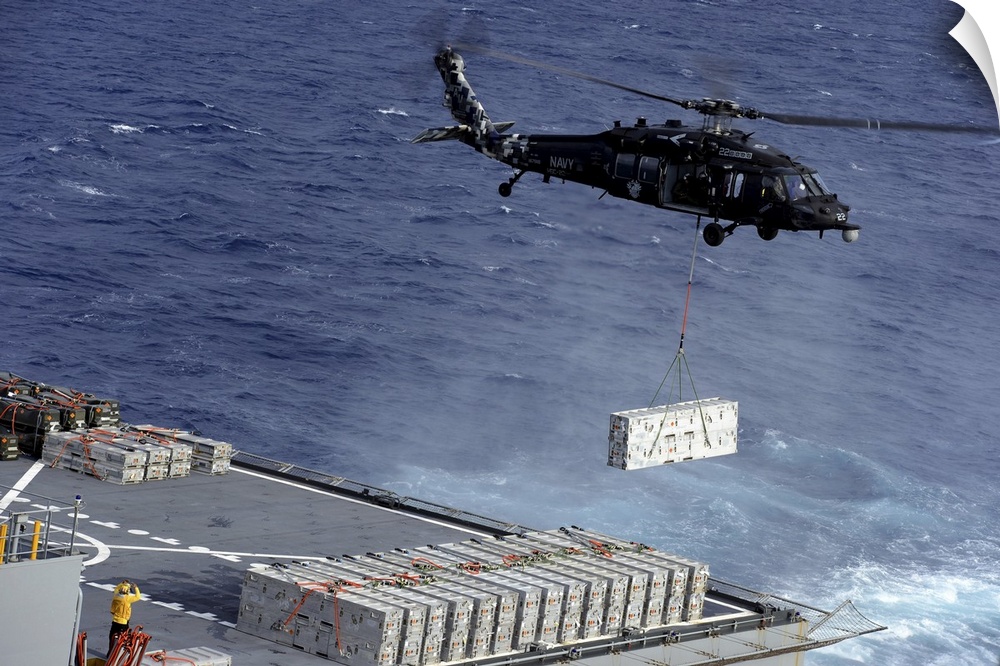 Atlantic Ocean, January 15, 2013 - An MH-60S Sea Hawk helicopter picks up ammunition from the Military Sealift Command dry...