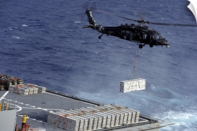 An MH-60S Sea Hawk Helicopter Picks Up Ammunition From USNS William Mclean