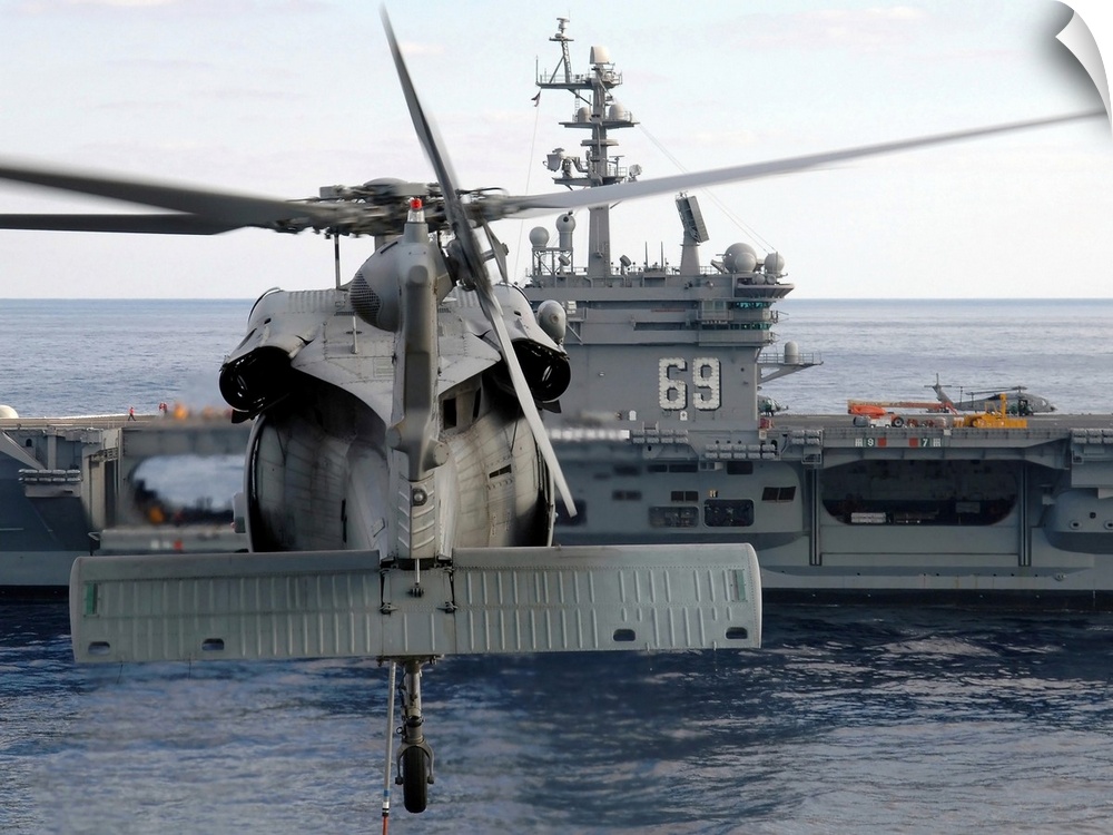 Atlantic Ocean, November 5, 2005 - An MH-60S Seahawk helicopter hovers prior to taking a load of ammunition to the Nimitz-...