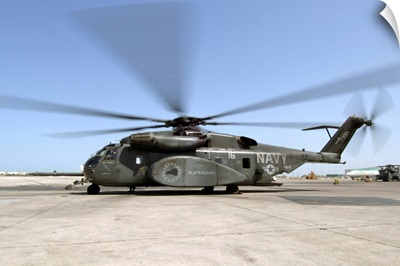 An MH53E Sea Dragon helicopter sits ready on the flight line