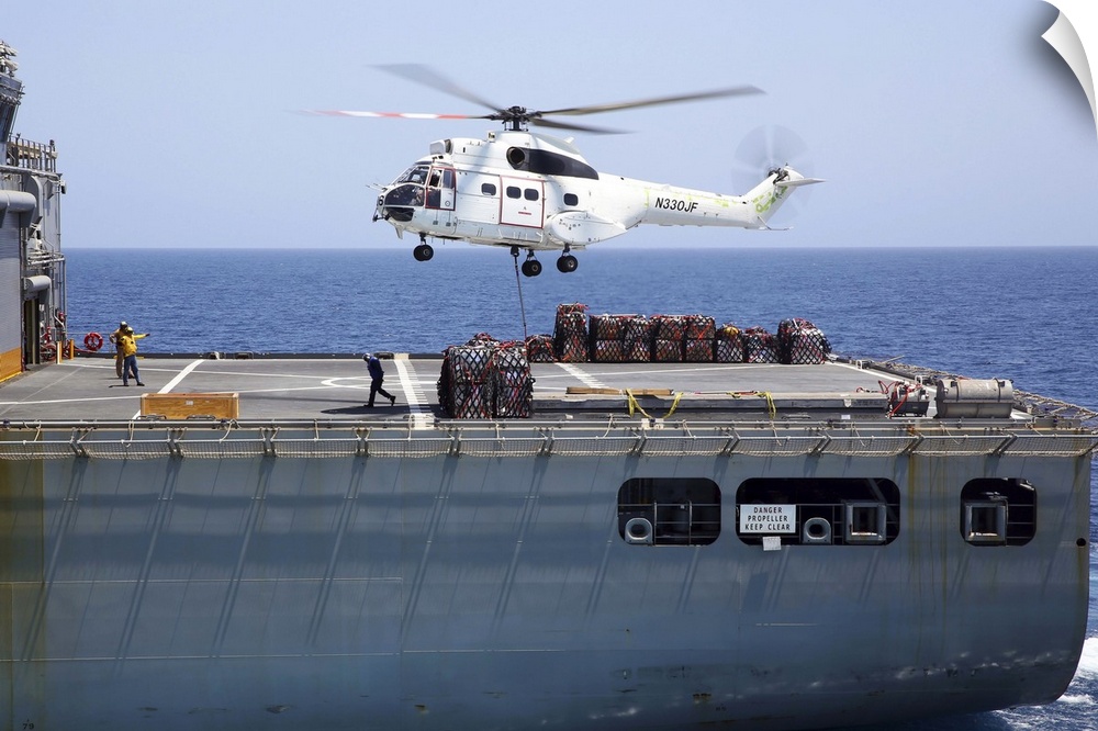 Gulf of Oman, September 5, 2013 - An SA-330J Puma helicopter approaches the dry cargo and ammunition ship USNS Cesar Chave...