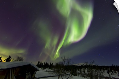 Aurora borealis above a cabin at Fish Lake, Whitehorse, Yukon, Canada