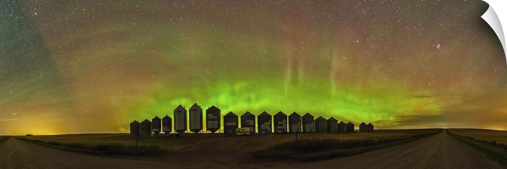 A 180 degree panorama of a modest aurora display behind grain bins on a country road in Alberta, Canada. The aurora adds m...