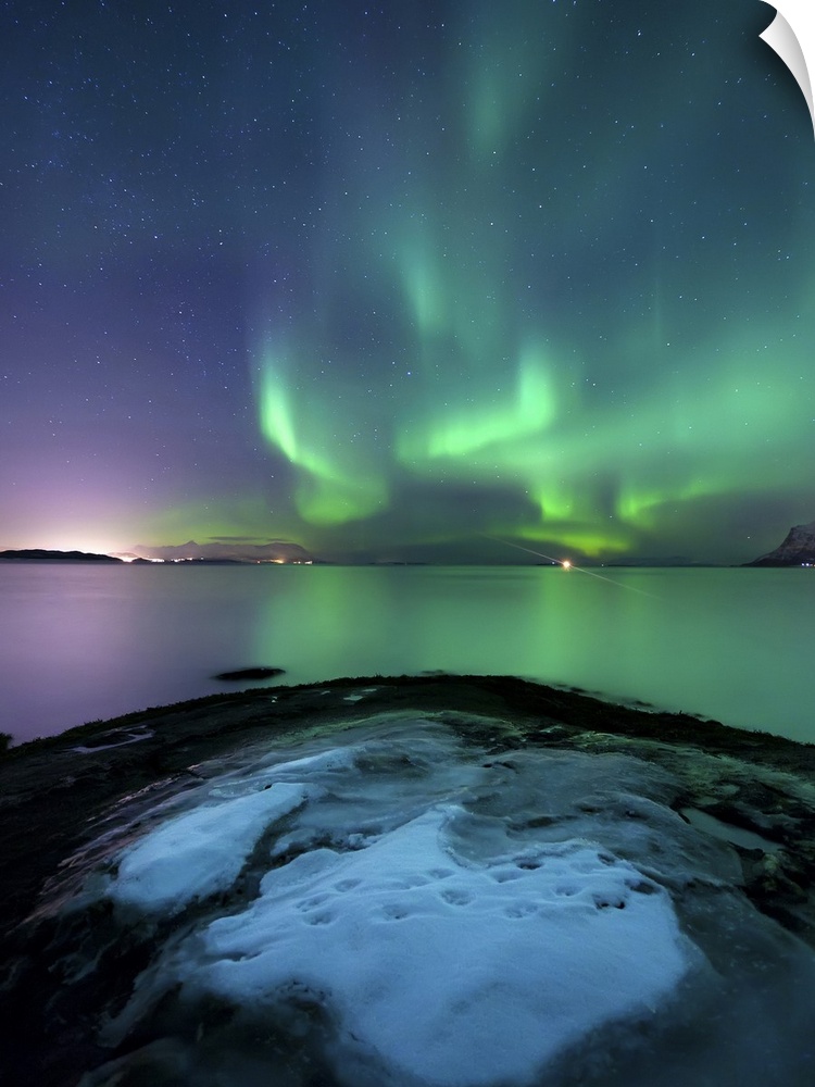 Aurora Borealis over Vagsfjorden outside of Harstad in Northern Norway. Auroras are the result of the emissions of photons...