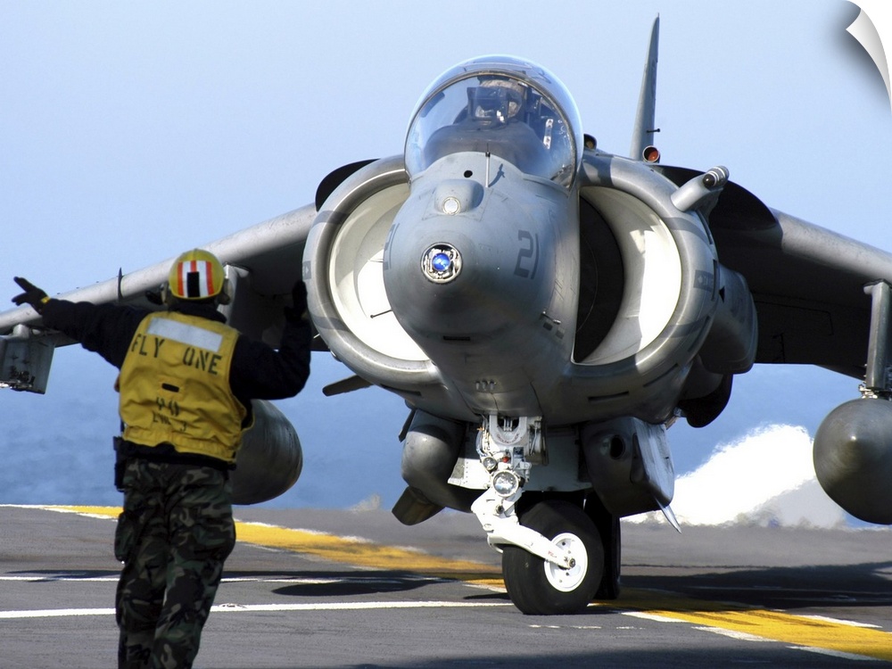 Atlantic Ocean, January 10, 2005 - Aviation Boatswain's Mate directs an AV-8B Harrier to turn right on the flight deck of ...