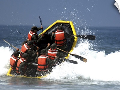 Basic Underwater Demolition/SEAL students battle through the surf