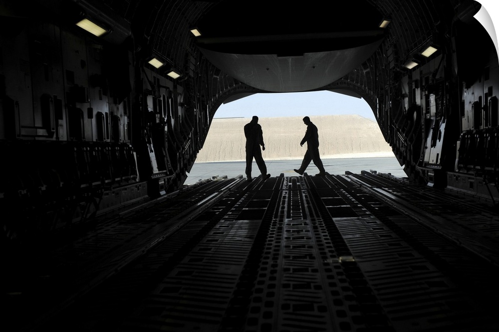 January 20, 2010 - C-17A Globemaster III loadmasters go through prefight checks on the ramp prior to loading cargo for an ...