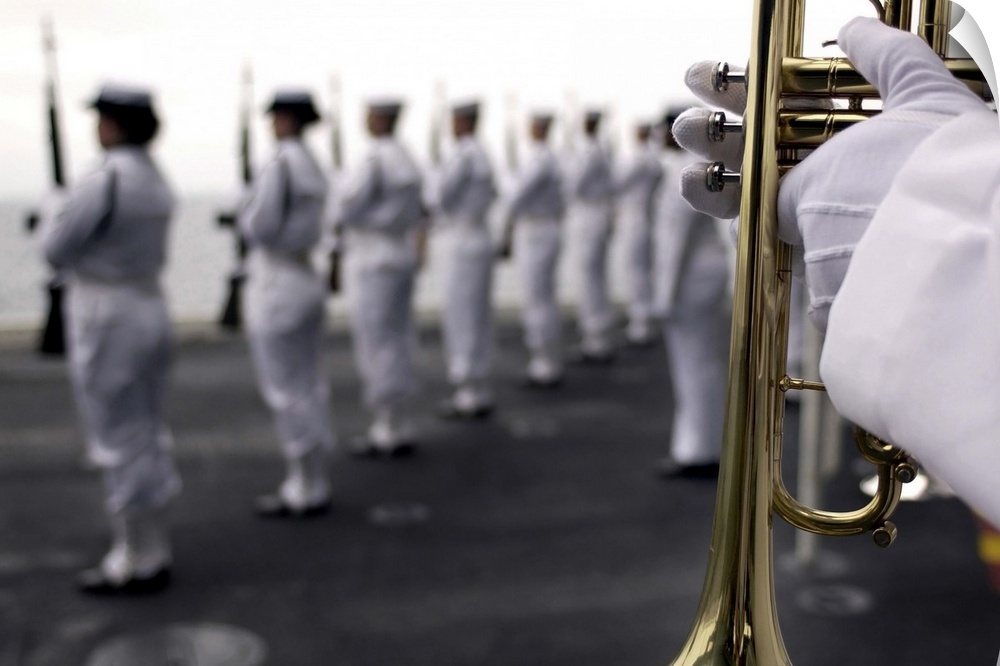 Ceremonial Honor Guard members stand at port arms during a burial at sea ceremony