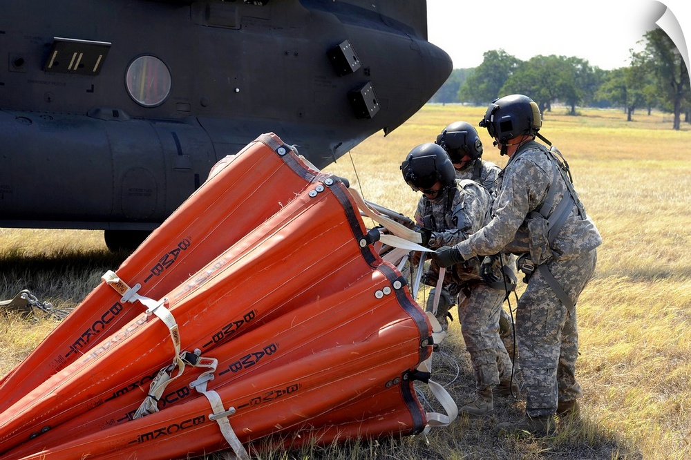 September 6, 2011 - CH-47 Chinook helicopter crew prepare to install the Bambi Bucket on the aircraft. Texas National Guar...