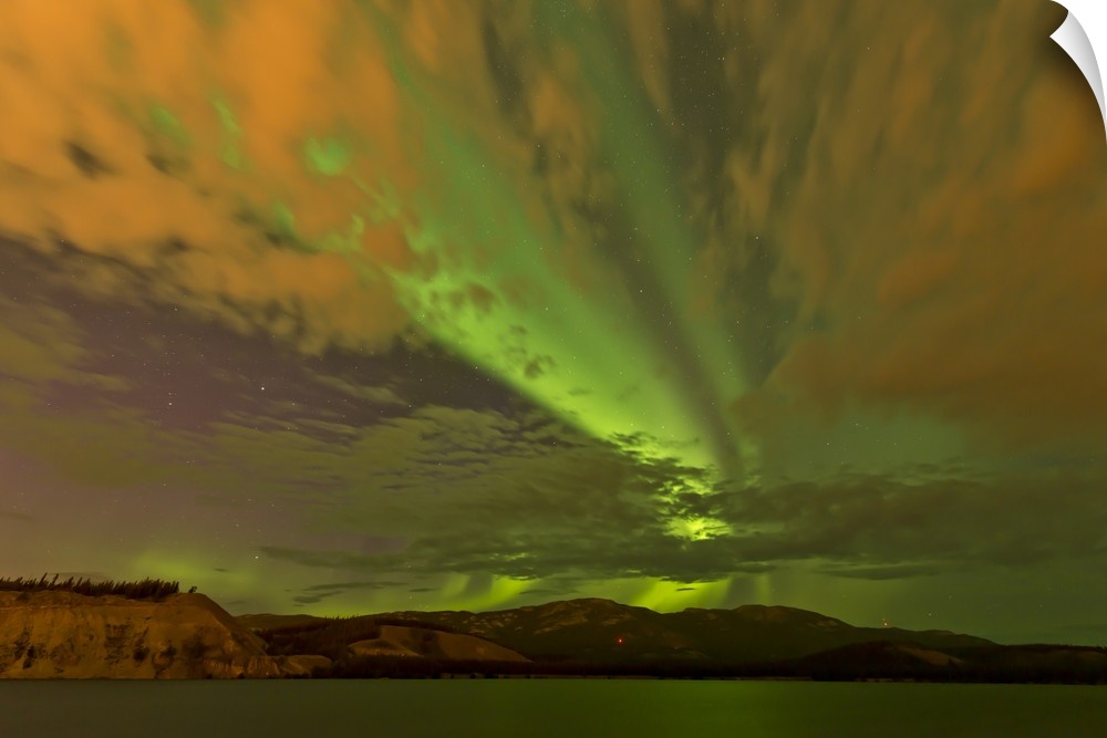 Colorful aurora borealis over lake, Yukon, Canada.