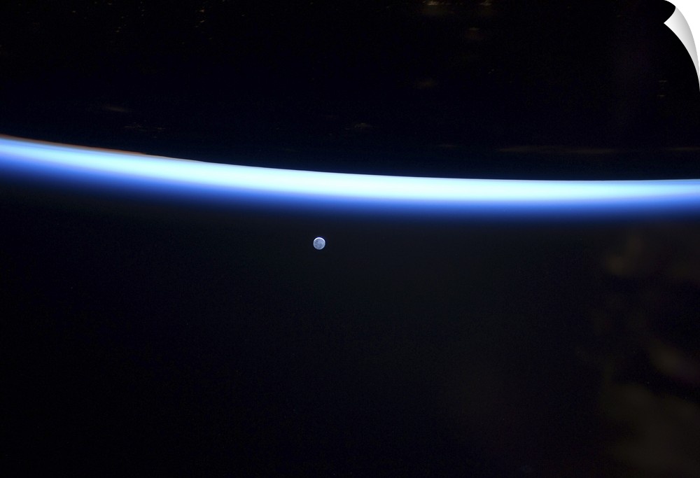 March 6, 2011 - Earth's thin line of atmosphere and a gibbous moon.