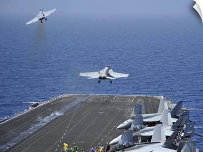F/A-18F Super Hornets launch from the aircraft carrier USS Enterprise