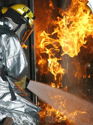 Firefighter Extinguishes A Simulated Structural Fire