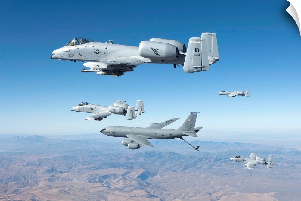 Four A-10C Thunderbolt's from the 190th Fighter Squadron prepare to recieve fuel from a KC-135 aerial refueling tanker ove...