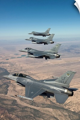 Four F-16s maneuver on a training mission over the Arizona desert