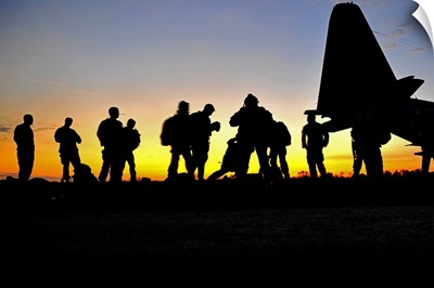 Green Berets prepare to board a KC-130 aircraft