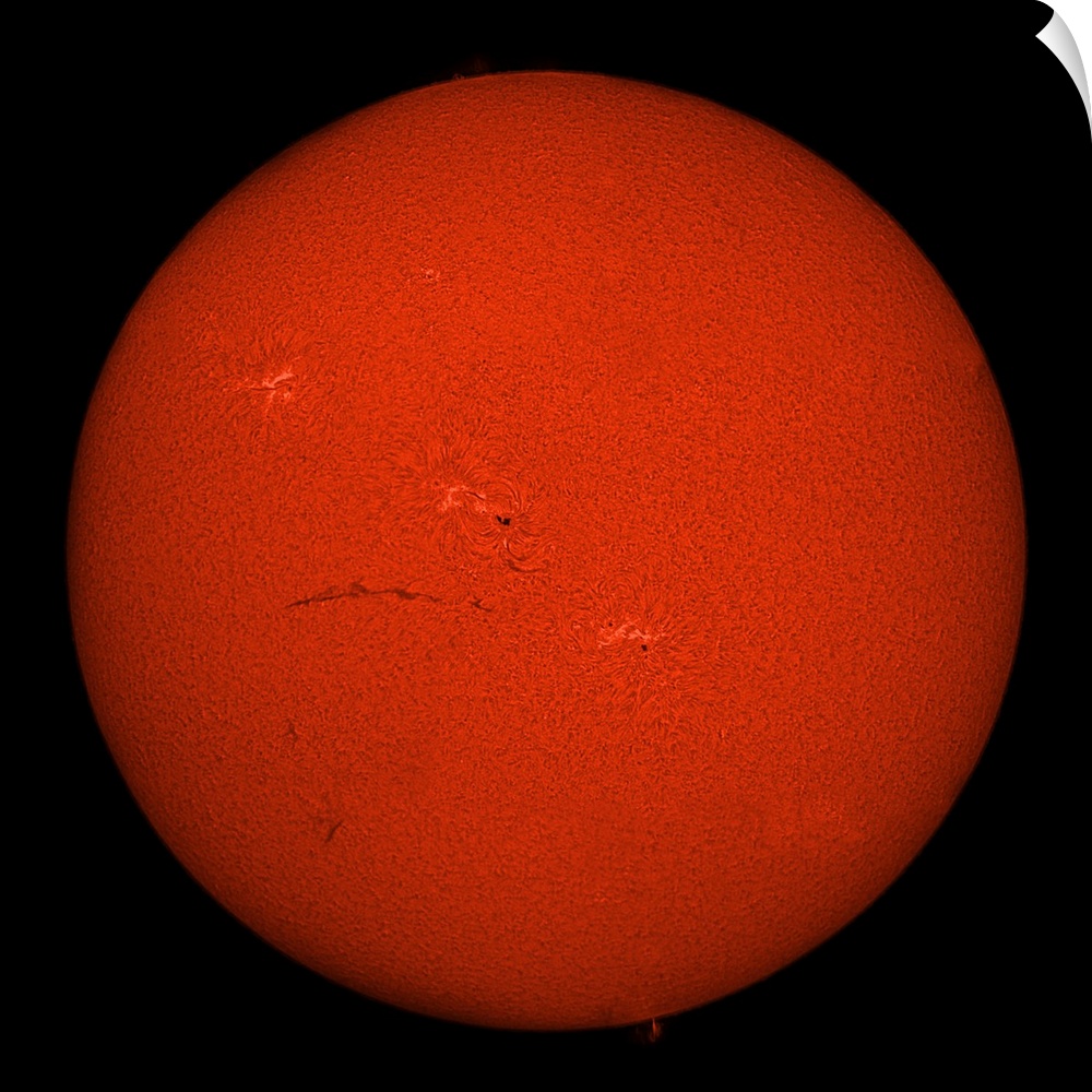 H-alpha full Sun in red color with active areas and filaments.
