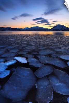 Ice flakes drifting towards the mountains on Tjeldoya Island, Norway