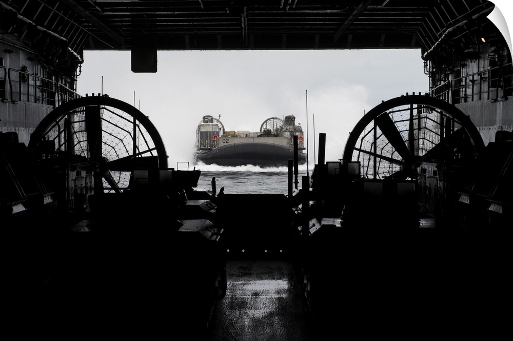 Atlantic Ocean, January 25, 2013 - Landing Craft Air Cushion approaches the well deck of the amphibious transport dock shi...