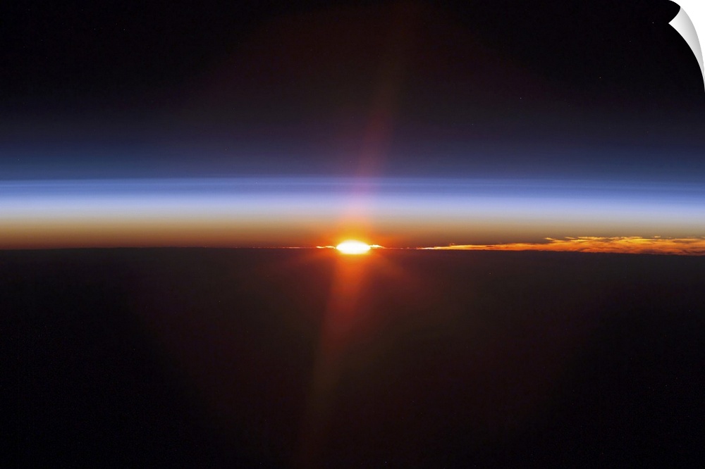 Aerial photograph of a clear sky at dusk with glowing sun rays.