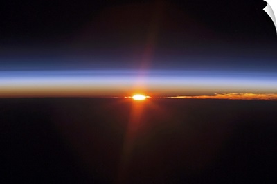 Layers of Earths atmosphere brightly colored as the sun sets over South America
