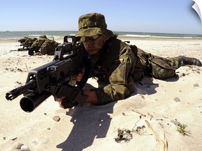 Lithuanian Special Forces Members Lie In Formation On A Beach