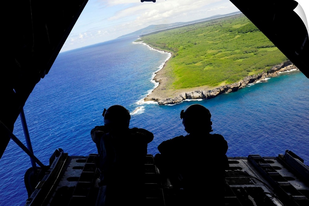 February 23, 2011 - Loadmasters admire the view from the back of a C-130 Hercules over Tumon Bay, near Guam, during Exerci...