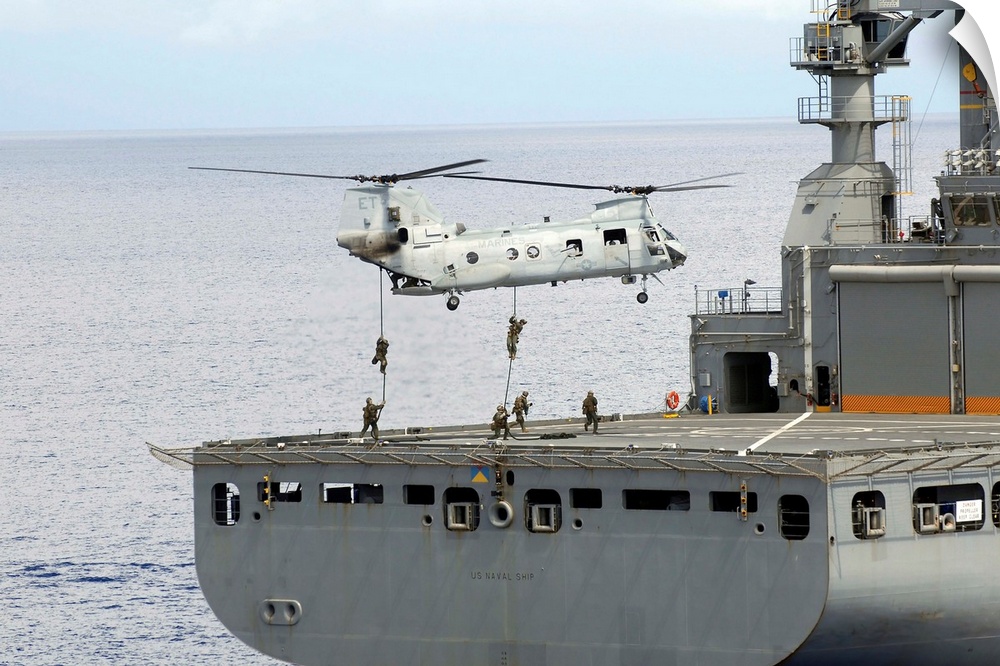 Philippine Sea, September 18, 2010 - Marines embarked aboard the amphibious assault ship USS Essex, fast rope from a CH-46...