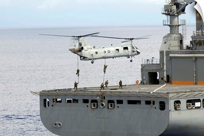 Marines fasten rope from a CH 46 Sea Knight helicopter