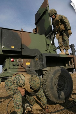 Marines prepare the antenna of an AN/TPQ 46A radar system