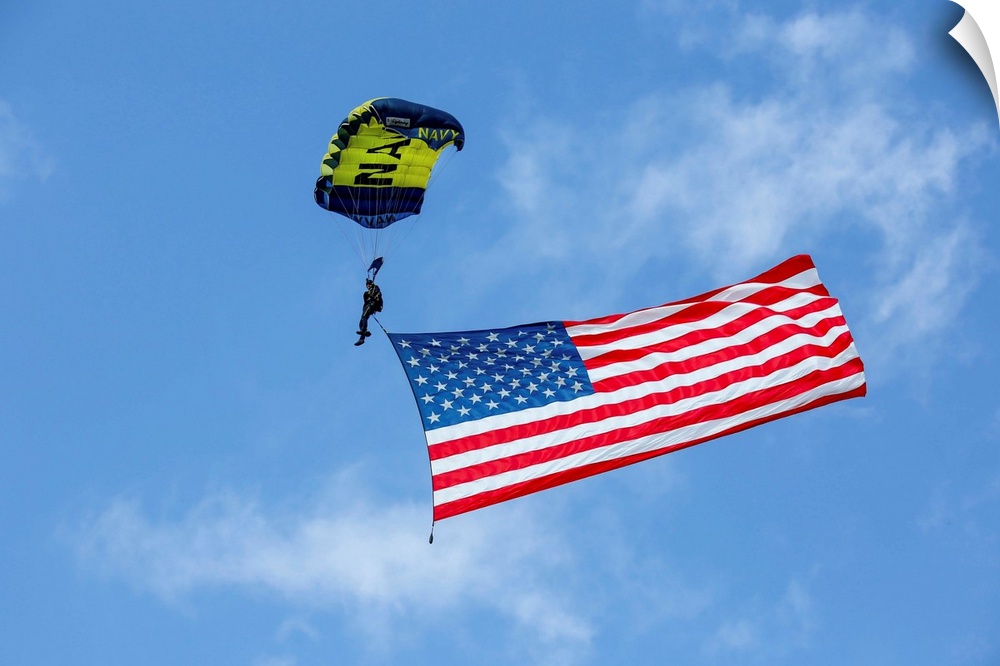 Member of the U.S. Navy Parachute Team flies the American Flag.