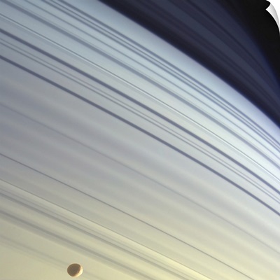 Mimas drifts along in its orbit against the azure backdrop of Saturns northern latitudes