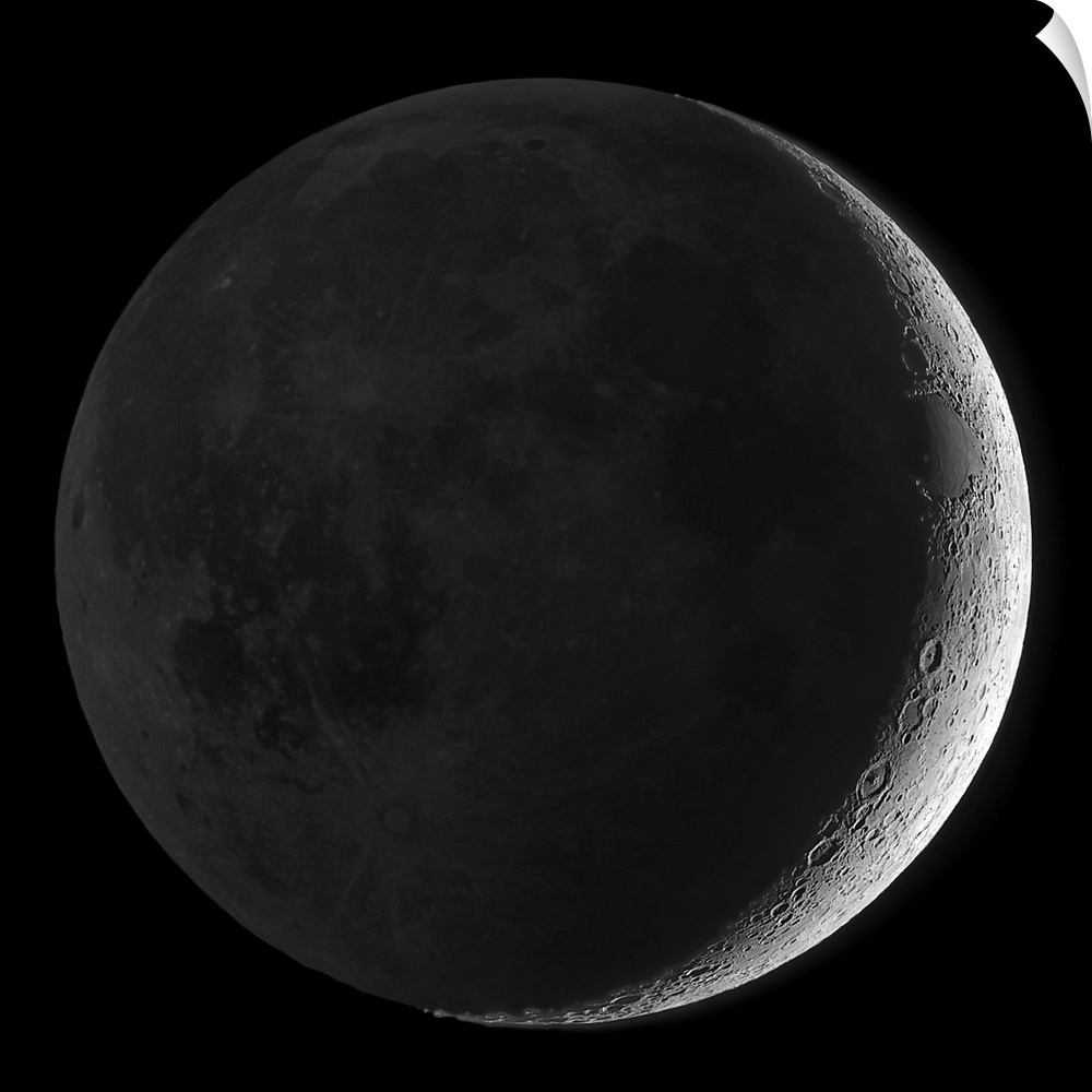 Giant square wall picture of the moon, dark except a small sliver on one side, surrounded by a black background.