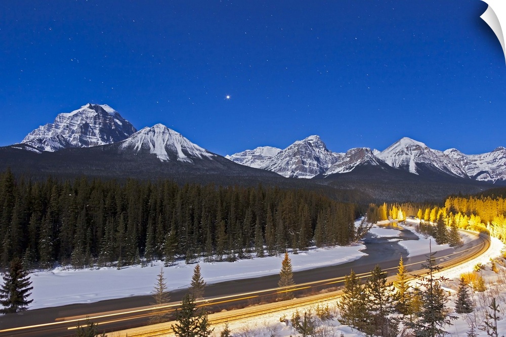 February 4, 2012 - A moonlit nightscape with a gibbous Moon providing illumination over the Bow River and Morant's Curve i...
