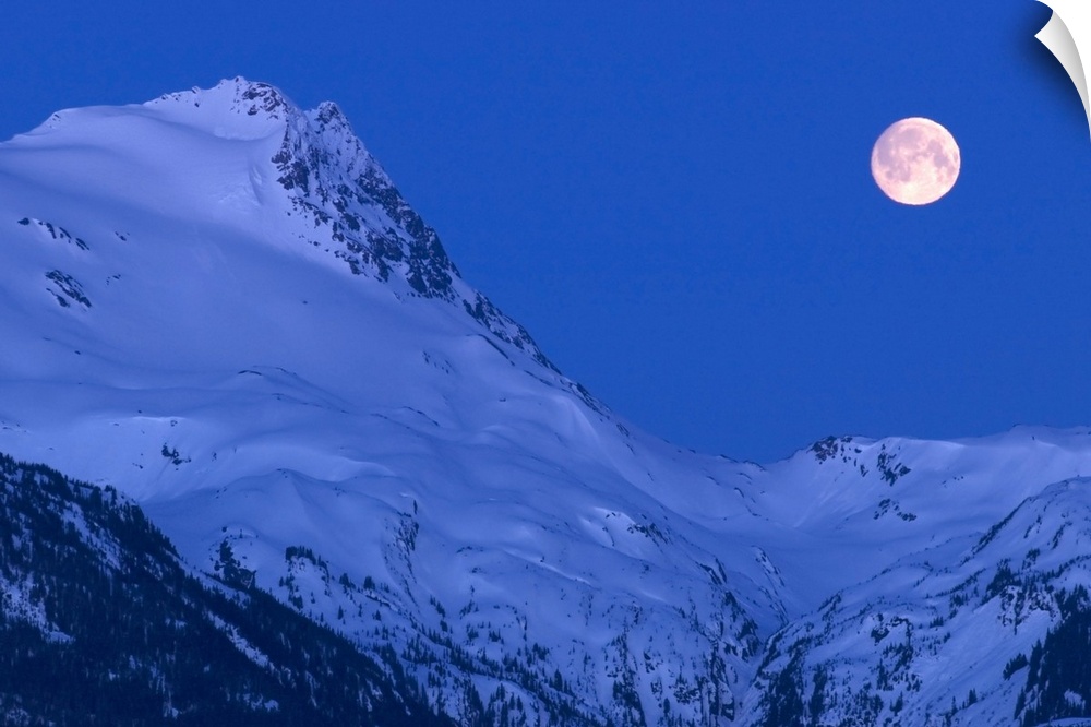 Large image on canvas of a full moon to the right of a tall snowy mountain ridge.