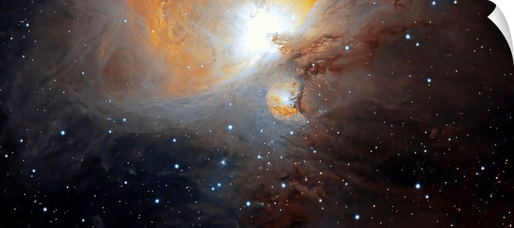 Space photograph of a large, bright nebula of swirling clouds dotted with stars in the constellation of Orion.