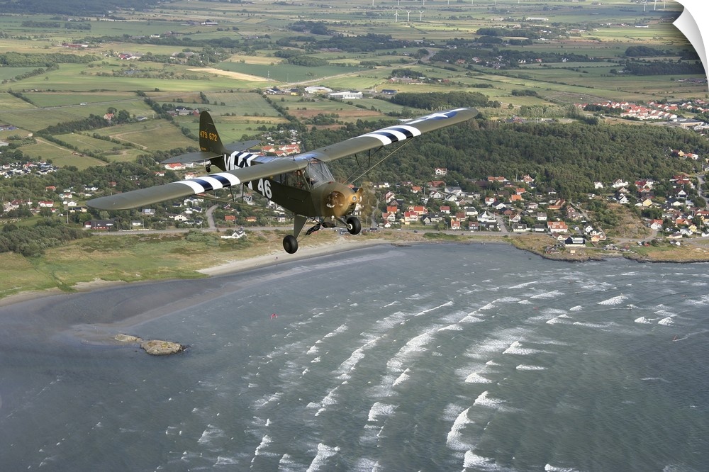 Varberg, Sweden - Piper L-4 Cub in US Army D-Day colors. Varberg, Sweden - Piper L-4 Cub in US Army D-Day colors.