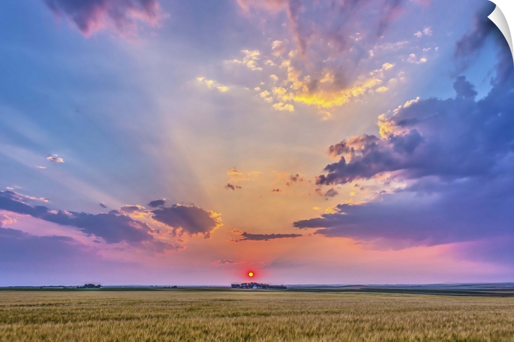 August 6, 2014 - High dynamic range photo of a red setting Sun in haze, casting shadows across the sky, crepuscular rays, ...