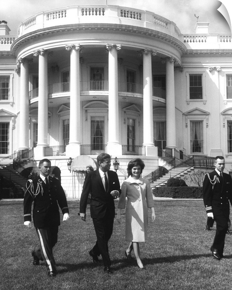 President John F. Kennedy and the First Lady in front of White House.