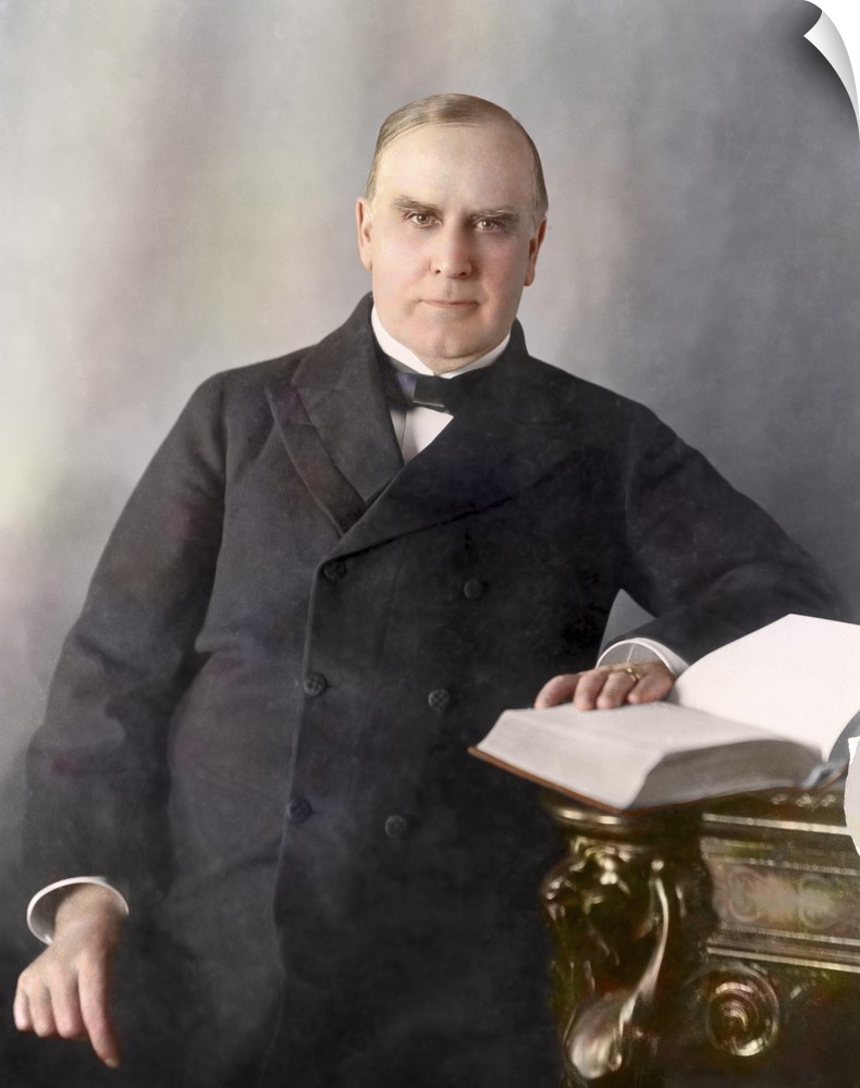 President William McKinley, half-length portrait, seated at desk, facing front, circa 1900.