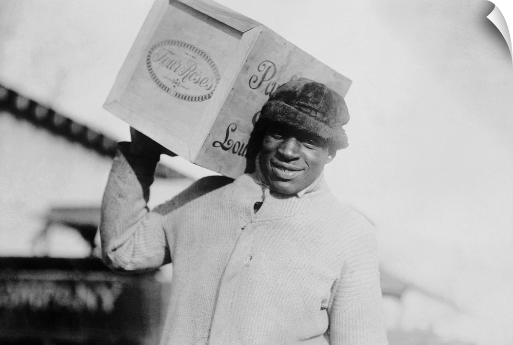 Prohibition era photograph of a man carrying a case of whiskey during the Great Depression.