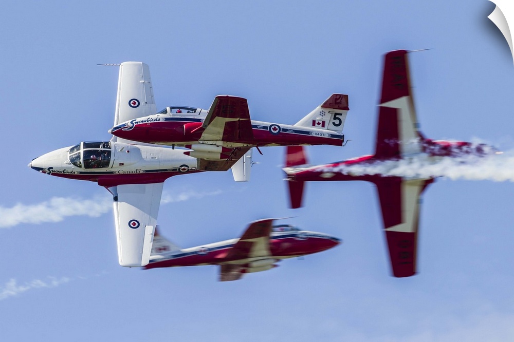 Four Royal Canadian Air Force Tutor trainer aircraft of the Snowbirds display team cross at Waukegan, Illinois.