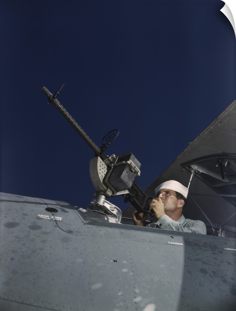 August 1942 - Sailor tries out a .30-caliber machine gun on a Navy plane at Naval Air Base, Corpus Christi, Texas.