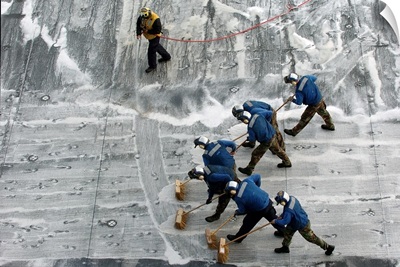 Sailors conduct a Scrub Exercise on the flight deck aboard USS Peleliu