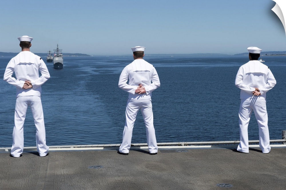 Seattle, Washington, July 30, 2014 - Sailors man the rails of the Wasp-class amphibious assault ship USS Essex (LHD 2) as ...