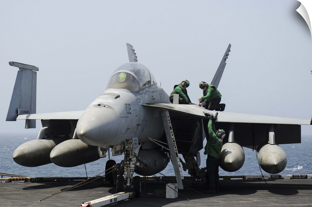 Gulf of Oman, August 22, 2013 - Sailors perform maintenance on an F/A-18F Super Hornet aboard the flight deck of the aircr...