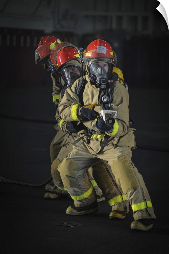 Pacific Ocean, July 25, 2014 - Sailors practice firefighting during a drill in the hangar bay of the aircraft carrier USS ...