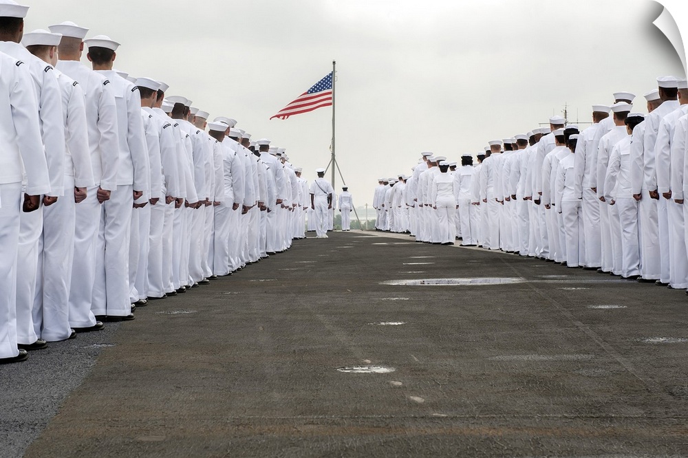 Atlantic Ocean, July 22, 2013 - Sailors prepare to man the rails on the flight deck of the aircraft carrier USS Harry S. T...