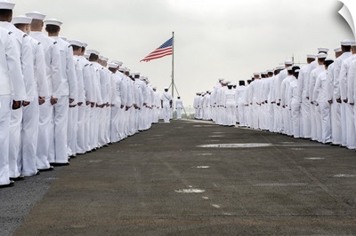 Sailors prepare to man the rails on the flight deck of USS Harry S. Truman